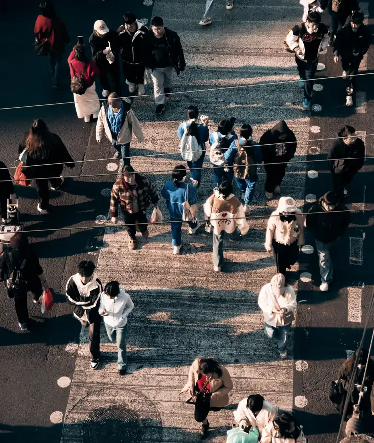 Crowds moving through a city crossing