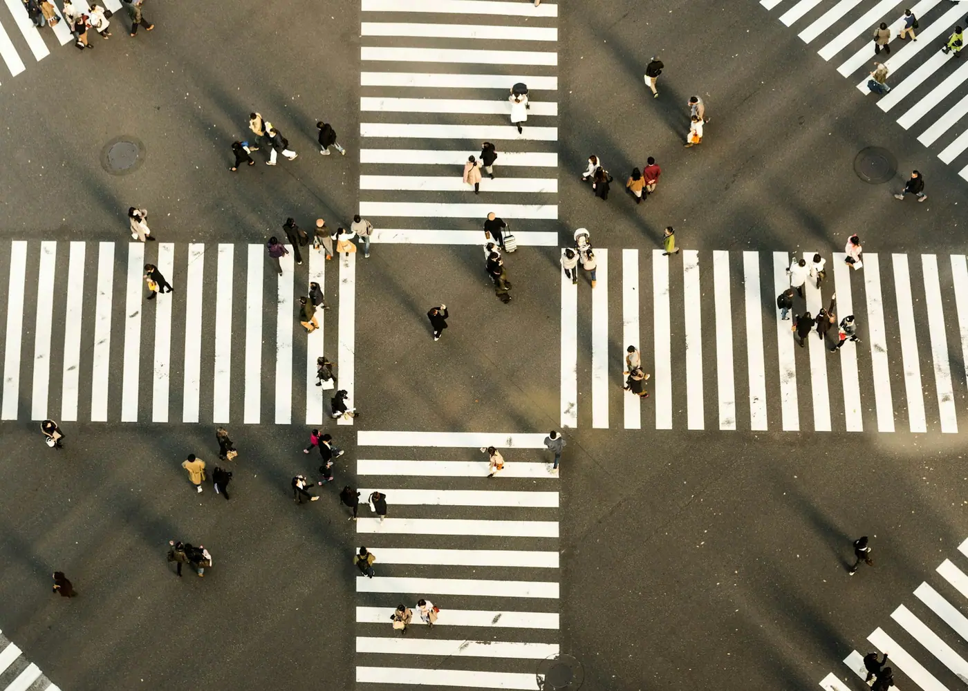 People moving through an urban crossing seen from above