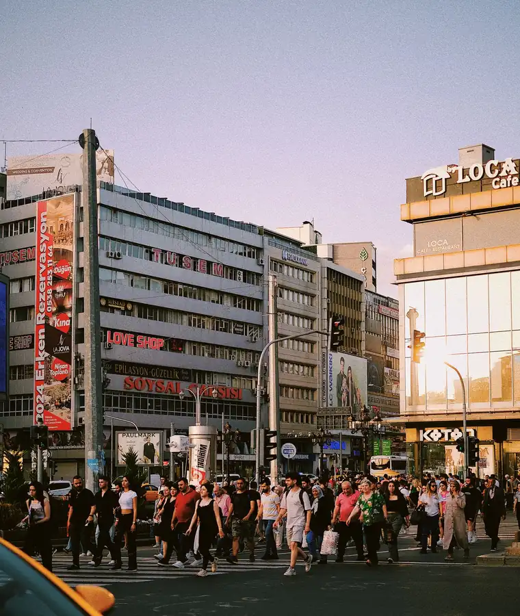 Dense streams of people moving through a commercial district